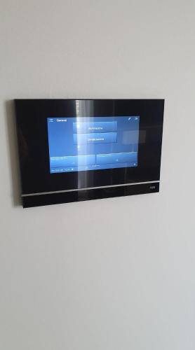 a flat screen tv hanging on a wall at Hotel Kuma in San Giuseppe