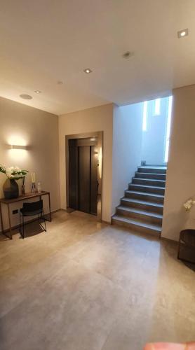 an empty room with a staircase in a building at Hotel Kuma in San Giuseppe