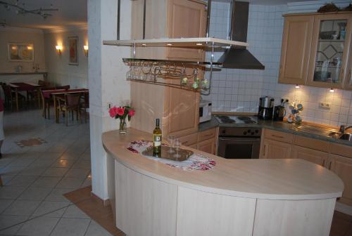 a kitchen with a counter with a bottle of wine at Pension Wortmann in Bad Laer