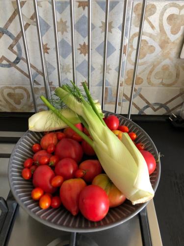 a bowl of fruit and vegetables on a chair at B&B Villa le Ortensie in Faggeto Lario 