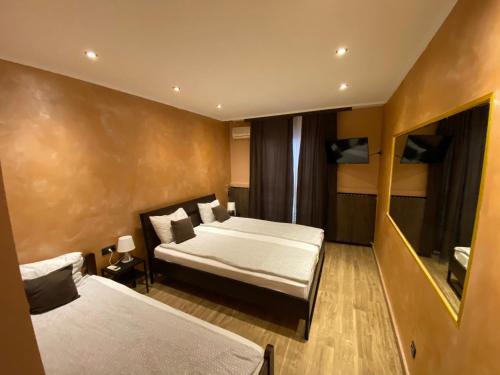 a hotel room with two beds and a television at Motel Stari Hrast in Markovac