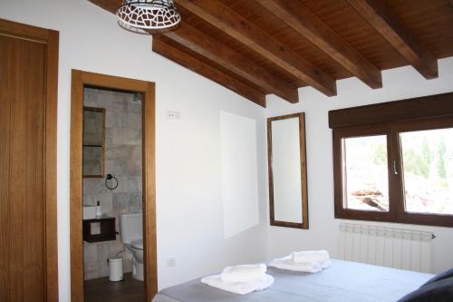 a bedroom with a bed with two towels on it at Casa Rural Avellaneda in Avellaneda