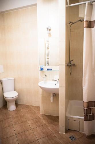 a bathroom with a toilet and a sink and a shower at Żaczek Hotele Studenckie in Krakow