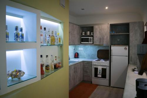 a kitchen with a white refrigerator and a stove at Dolichi View in Pythagoreio