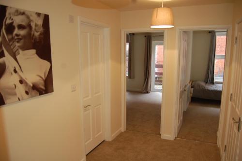 a hallway with a painting of a man on the wall at 18A Milford Street in Salisbury