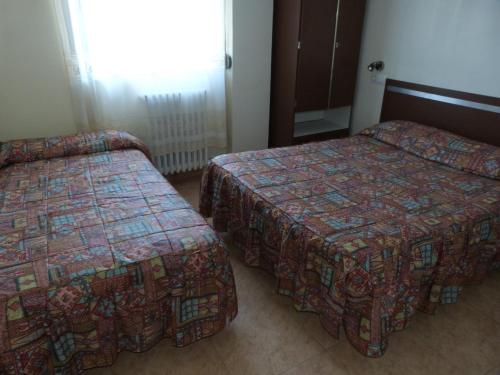 Postel nebo postele na pokoji v ubytování Hostal Isabel