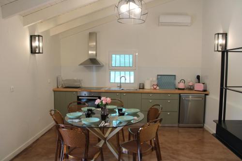 a kitchen with a table and chairs in a kitchen at Apothiki House in Kato Korakiana