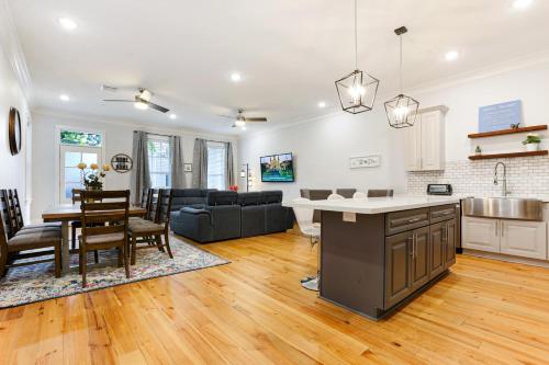 a kitchen and living room with a table and a couch at Stunning Modern and Fully-Upgraded 5 BR w Pool in New Orleans