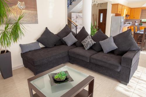 a living room with a couch and a table at Villa Paradise in Paphos