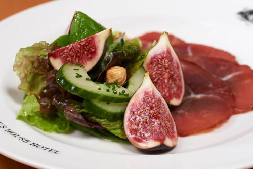 a plate of food with blood figs and greens at The Prince's House Hotel in Glenfinnan