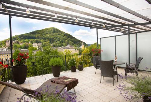 a patio with a view of a mountain at Bad Emser Hof in Bad Ems
