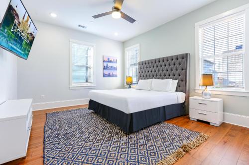 a bedroom with a large bed and a tv at Hosteeva Chic Urban Retreat w Pool Steps to St Charles Ave and Near Bourbon St in New Orleans