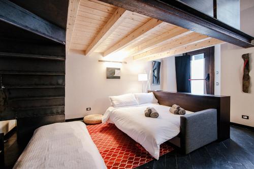 a bedroom with a large bed and a large window at Palazzo Del Pero - The House Of Travelers in Como