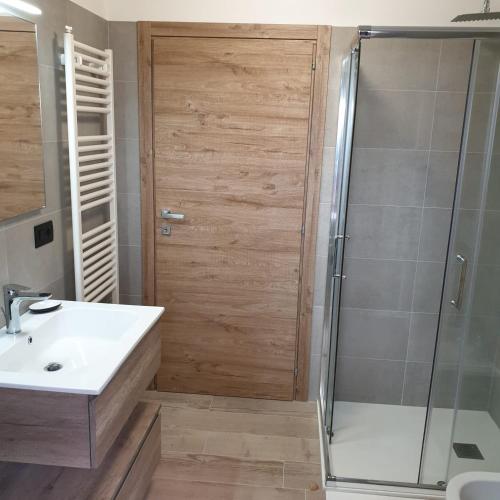 a bathroom with a shower and a sink and a shower stall at Casa Tiziano e Nila in Santo Stefano di Cadore