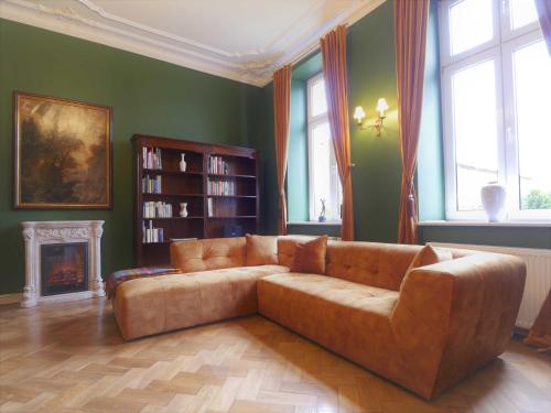 a living room with a couch and a fireplace at Schlosshotel Gross Koethel in Hohen Demzin