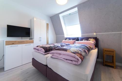 Ένα ή περισσότερα κρεβάτια σε δωμάτιο στο Ferienhaus Deichstraße 8