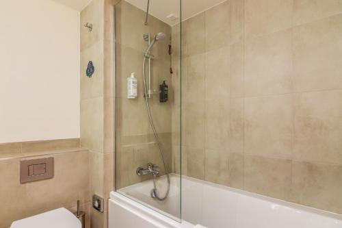 a bathroom with a shower with a tub and a toilet at ibis Styles Bucharest City Center in Bucharest