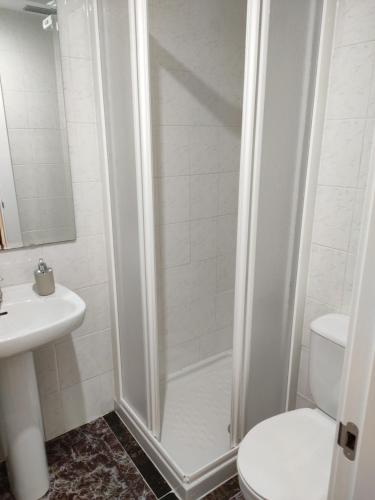 a bathroom with a shower with a toilet and a sink at Tropicana Park in Gandía
