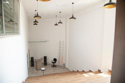 a room with a white wall and pendant lights at The Era Otel in Gölhisar