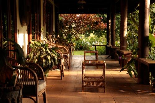 a row of chairs and tables on a patio at Terres Rouges Lodge in Banlung