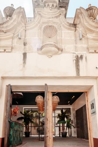 an open door to a building with plants on it at ASTUTO Boutique Jerez - Adults Only in Jerez de la Frontera