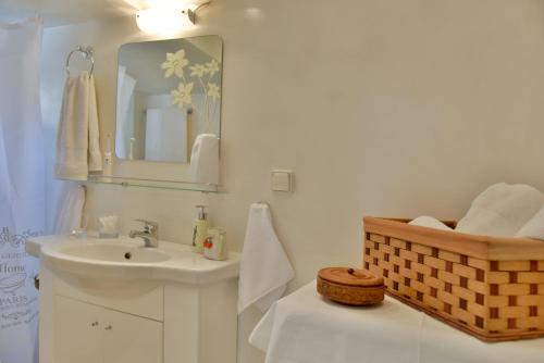 a bathroom with a sink and a mirror at Grandmas Guest House in Hydra