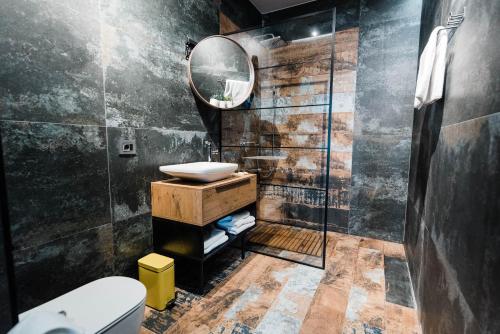 a bathroom with a sink and a mirror at Square 19-Boutique rooms in Novi Sad
