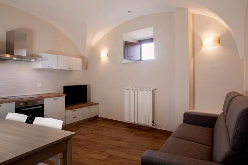 a kitchen and living room with a couch and a table at Residenza Cappelli - Case Vacanze in San Demetrio neʼ Vestini