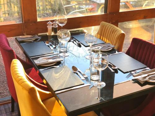 a table in a restaurant with wine glasses on it at The Blue Bell Crookham in Cornhill-on-tweed