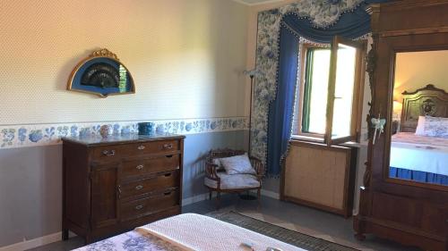 a bedroom with a bed and a dresser and a window at Agriturismo La CasinaRosa in Loreto Aprutino