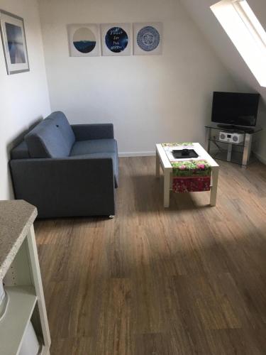 a living room with a couch and a coffee table at Gaestehaus-Sylvie-Wohnung-2 in List
