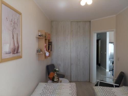 a bedroom with a bed and a cabinet and a table at Apartament w Głogowie in Głogów