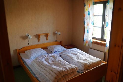 מיטה או מיטות בחדר ב-Fjällriket Baggården