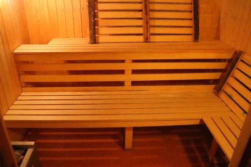 a sauna with a wooden bench in a room at Fjällriket Baggården in Baggården