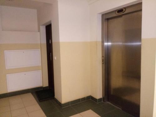a bathroom with a shower and a door at Apartament w Głogowie in Głogów