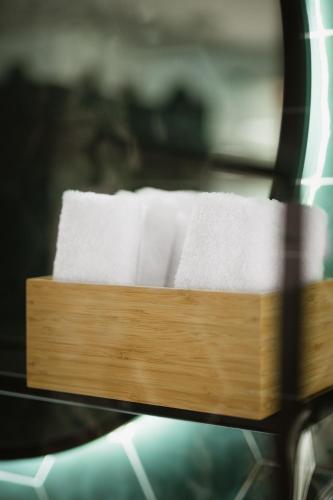 a pile of towels sitting on top of a machine at The Bold Type Hotel, a Member of Design Hotels in Patra