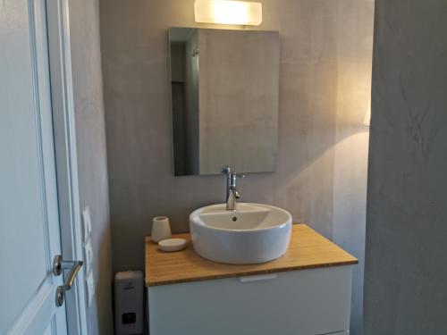 a bathroom with a white sink and a mirror at The Elephant Beach House in Kimolos