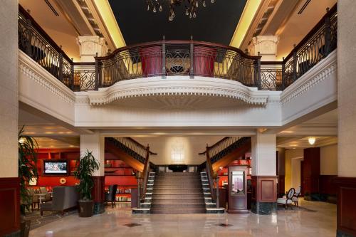 a large room with a large staircase leading to a lobby at The Stephen F Austin Royal Sonesta Hotel in Austin