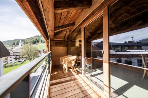 a balcony of a house with glass doors at Wassermann in Sesto