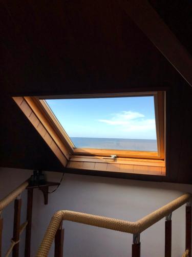 a window in a room with a view of the ocean at Hotel Fonte do Fraile in Malpica