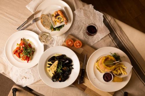 a table with four plates of food on it at Warkworth House Hotel in Warkworth
