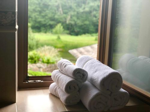 a pile of towels sitting on a window sill at Jūrvingė in Žadvainai