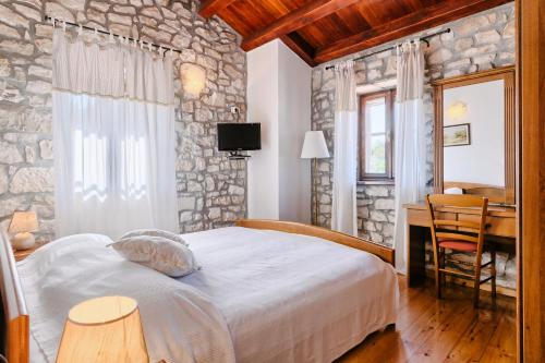 a bedroom with a bed with a stone wall at Haus Albino in Kršan