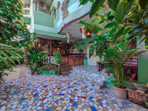 a courtyard of a building with trees and plants at Awana House in Chiang Mai