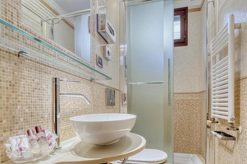 a bathroom with a bowl sink and a shower at Hotel Al Piave in Venice