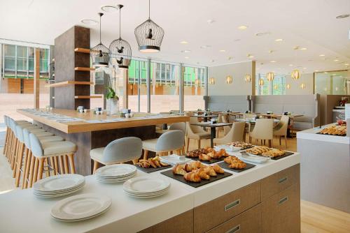 a kitchen with a table with plates of food on it at NH Trento in Trento