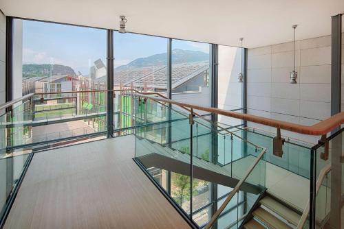 a glass staircase in a building with a view at NH Trento in Trento