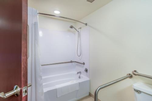 a bathroom with a shower and a sink at Burrstone Inn, Ascend Hotel Collection in Utica