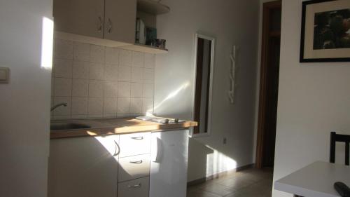 a kitchen with white cabinets and a sink at Viola in Skradin