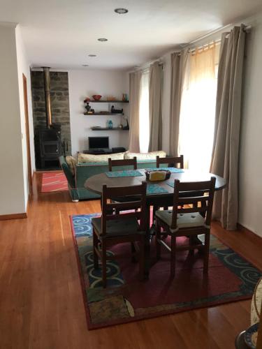 a living room with a table and chairs and a couch at Casas Botelho Elias in Pinhão